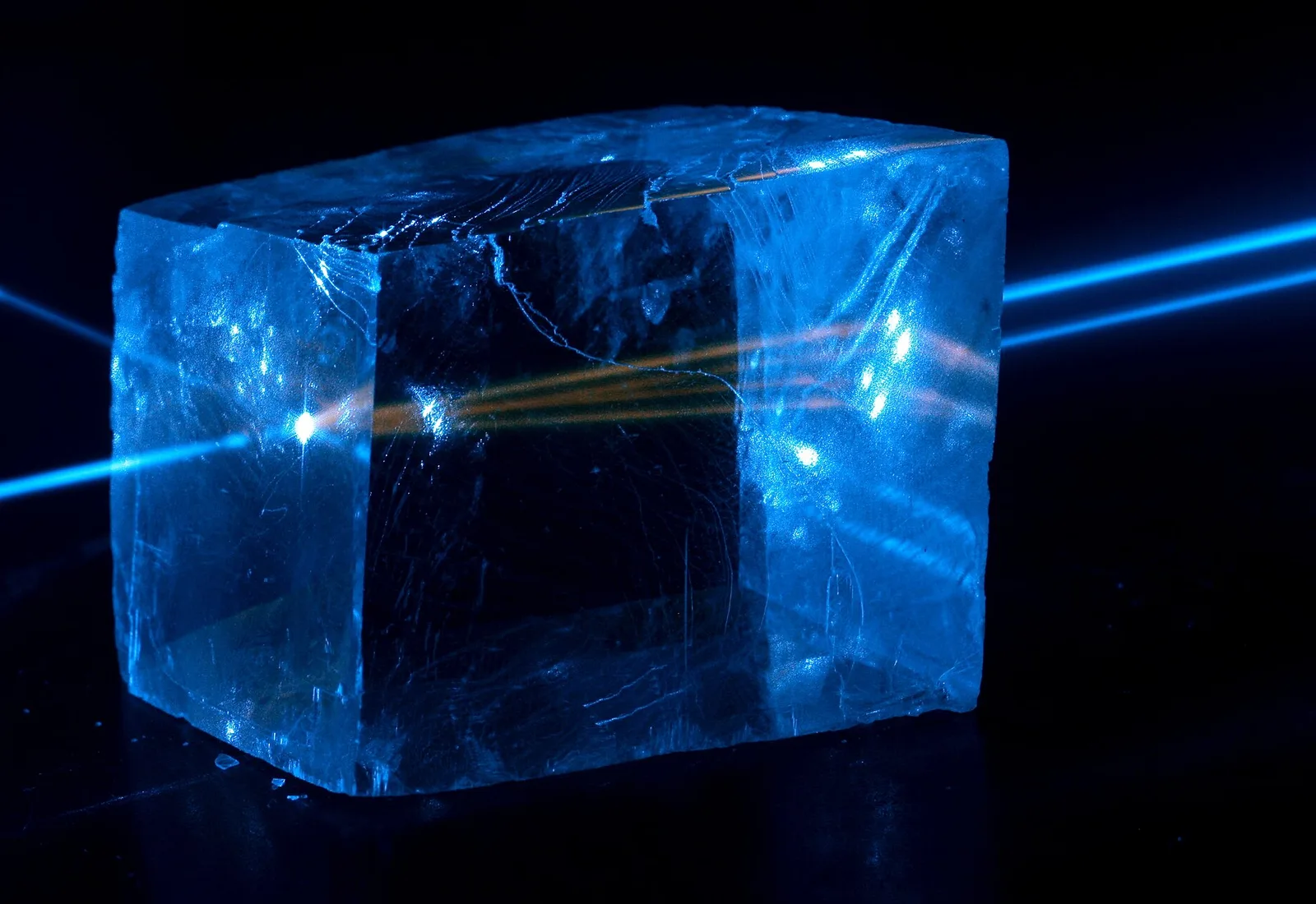 A mineral glowing blue under ultraviolet light